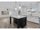 Open concept kitchen with large island, white cabinets, and eat-in area at 18998 E Lark Dr, Queen Creek, AZ 85142