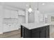 Kitchen with center island with quartz countertops, modern lighting, and custom cabinetry at 18998 E Lark Dr, Queen Creek, AZ 85142