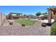 Expansive backyard with dining area, patio furniture, lush lawn, rock accents, pool and spa, ideal for outdoor living at 2041 E Palm Beach Dr, Chandler, AZ 85249