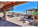 The backyard patio features shade structures, an outdoor grill, and comfortable seating with a pool nearby at 2041 E Palm Beach Dr, Chandler, AZ 85249