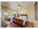 Bedroom featuring a mirrored closet, ceiling fan, and a comfortable bed with wood flooring at 2041 E Palm Beach Dr, Chandler, AZ 85249