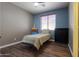 Bedroom with minimalist decor, featuring wood floors, and a well-lit atmosphere at 2041 E Palm Beach Dr, Chandler, AZ 85249