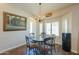 Bright dining area featuring a glass table, chandelier, and a large window with natural light at 2041 E Palm Beach Dr, Chandler, AZ 85249