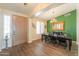 Elegant dining room featuring wood floors, chandelier, and decorative green accent wall at 2041 E Palm Beach Dr, Chandler, AZ 85249