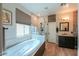 Bright bathroom features a large bathtub, glass enclosed shower, and stylish vanity with modern fixtures at 2041 E Palm Beach Dr, Chandler, AZ 85249