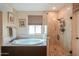Serene bathroom with a soaking tub, walk-in shower, and natural light from a bright window at 2041 E Palm Beach Dr, Chandler, AZ 85249