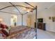 Beautiful main bedroom showcasing a four-post bed, ceiling fan, TV, and access to the bathroom at 2041 E Palm Beach Dr, Chandler, AZ 85249