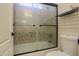 Bathroom featuring a tiled shower stall with a glass door and built-in shelving at 2041 E Palm Beach Dr, Chandler, AZ 85249
