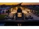 Outdoor lounge area with fire pit at dusk and plenty of seating for socializing at 22682 E Indiana Ave, Queen Creek, AZ 85142