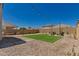 View of manicured backyard with Adirondack chairs, firepit, and bench at 22682 E Indiana Ave, Queen Creek, AZ 85142