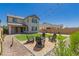 Landscaped backyard with fire pit and Adirondack chairs at 22682 E Indiana Ave, Queen Creek, AZ 85142