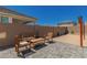Backyard brick patio with seating and a wooden table at 22682 E Indiana Ave, Queen Creek, AZ 85142