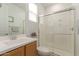 Bright bathroom featuring a glass-enclosed shower and single sink vanity at 22682 E Indiana Ave, Queen Creek, AZ 85142