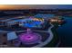 Aerial image showcases community amenities, including pools, clubhouses, and recreational areas illuminated at dusk at 22682 E Indiana Ave, Queen Creek, AZ 85142