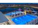 A community pool featuring a leisure pool, lap pool, sunshades and plenty of seating at 22682 E Indiana Ave, Queen Creek, AZ 85142