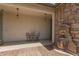 Inviting courtyard with a water fountain, two chairs, and a small table at 22682 E Indiana Ave, Queen Creek, AZ 85142