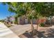 A picturesque home with brick accents, desert landscaping, and a spacious paved driveway at 22682 E Indiana Ave, Queen Creek, AZ 85142