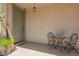 Welcoming front porch featuring a cozy seating area with a table and chairs at 22682 E Indiana Ave, Queen Creek, AZ 85142