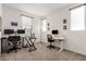 This office features two workstations, a bright window, and a neutral palette to create a calm working environment at 22682 E Indiana Ave, Queen Creek, AZ 85142