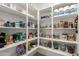 Organized walk-in pantry with plenty of shelving and storage space for food items and kitchen essentials at 22682 E Indiana Ave, Queen Creek, AZ 85142