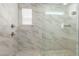 Modern glass shower with tiled walls, a window for natural light, and multiple shower heads at 22682 E Indiana Ave, Queen Creek, AZ 85142
