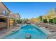 Backyard featuring a custom pool with rock features, desert landscaping, and mountain views at 24645 N 65Th Ave, Glendale, AZ 85310