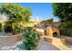 Backyard area featuring a wood-burning oven and inviting patio with desert landscaping at 24645 N 65Th Ave, Glendale, AZ 85310