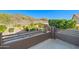 Balcony view of fenced backyard with desert landscaping, rock features, and patio furniture at 24645 N 65Th Ave, Glendale, AZ 85310