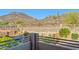 Balcony view of backyard with desert landscaping, block wall, and mountain in the distance at 24645 N 65Th Ave, Glendale, AZ 85310