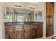 Bathroom boasting a dual sink vanity with granite countertop and walk-in shower at 24645 N 65Th Ave, Glendale, AZ 85310