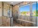 Bathroom with a marble tiled walk-in shower and shower bench at 24645 N 65Th Ave, Glendale, AZ 85310
