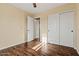 Bedroom features wood-look floors and closet with sliding doors at 24645 N 65Th Ave, Glendale, AZ 85310