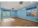 Bright bedroom with wood-style floors, modern lighting and backyard view from multiple windows at 24645 N 65Th Ave, Glendale, AZ 85310