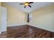 Bedroom featuring wood-look floors and a window with shade at 24645 N 65Th Ave, Glendale, AZ 85310