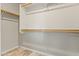 A walk-in closet with wooden rods for hanging clothing and linoleum flooring at 24645 N 65Th Ave, Glendale, AZ 85310
