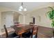 Dining area featuring elegant lighting, tile flooring, and access to stairway and other living spaces at 24645 N 65Th Ave, Glendale, AZ 85310