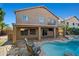Exterior view of home featuring a covered patio overlooking the custom pool and backyard at 24645 N 65Th Ave, Glendale, AZ 85310