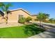 Desert home featuring manicured lawn, mature trees and desert landscaping, and inviting curb appeal at 24645 N 65Th Ave, Glendale, AZ 85310