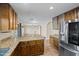 Open kitchen featuring granite countertops, stainless steel refrigerator, and tile flooring at 24645 N 65Th Ave, Glendale, AZ 85310