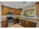 U-shaped kitchen with granite countertops, stainless appliances and lots of natural light at 24645 N 65Th Ave, Glendale, AZ 85310