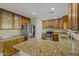 Well-lit kitchen with stainless steel appliances, granite countertops and tile floors at 24645 N 65Th Ave, Glendale, AZ 85310