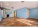 Living room featuring wood-style flooring and an adjacent kitchenette area at 24645 N 65Th Ave, Glendale, AZ 85310