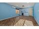 Living room featuring wood-style flooring and an adjacent kitchenette area at 24645 N 65Th Ave, Glendale, AZ 85310