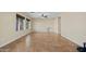 Open-concept living room with neutral walls, tile flooring, and natural light, perfect for casual living at 24645 N 65Th Ave, Glendale, AZ 85310