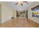 Open-concept living area with tile flooring, recessed lighting, kitchen, and outdoor view at 24645 N 65Th Ave, Glendale, AZ 85310