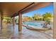 Covered patio overlooking a custom pool with rock features and desert views at 24645 N 65Th Ave, Glendale, AZ 85310