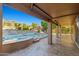 Inviting outdoor pool area with a covered patio, waterfall feature, and lush landscaping at 24645 N 65Th Ave, Glendale, AZ 85310