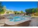 Backyard pool surrounded by desert landscaping, rock features, and a privacy fence at 24645 N 65Th Ave, Glendale, AZ 85310