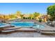 Beautiful pool with rock accents, desert landscaping, and outdoor seating area at 24645 N 65Th Ave, Glendale, AZ 85310