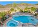 Aerial view of backyard with a pool, spa, waterfall feature, and desert landscaping at 24645 N 65Th Ave, Glendale, AZ 85310